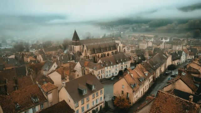 View of Beaune old town in France under a cloudy sky showcasing historic architecture and winding streets, Aerial of the old town of Beaune in France on a cloudy morning in early spring