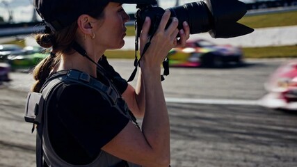 Professional photographer documenting high speed motorsport action at speedway, capturing dynamic racing moments with precision and focus through telephoto lens