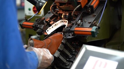 a craftsman handmade a shoe by a machine, close up shot, insert shot