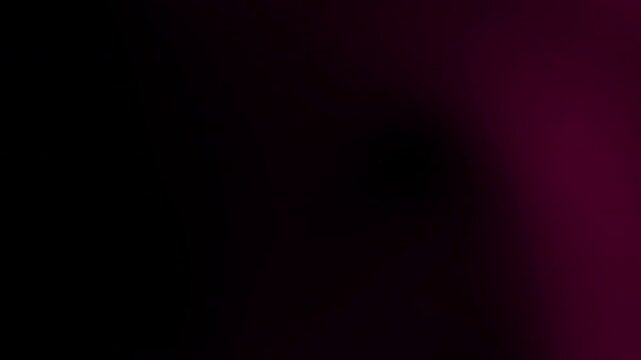 A dark abstract background with a gradient transitioning from deep black to rich maroon hues in the upper right corner.