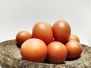a pile of eggs with a stone  background