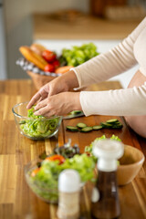 Pregnant Asian woman cooking healthy food at home