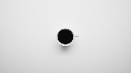 A white coffee cup with a black coffee inside sits on a white surface.