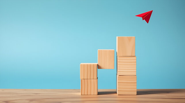 Wooden block stacking as step stair with red paper plane on blue background, Ladder of success in business growth concept, copy space