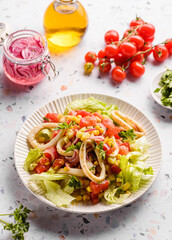 salad with squid, cucumbers, tomatoes and corn