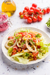 salad with squid, cucumbers, tomatoes and corn