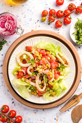 salad with squid, cucumbers, tomatoes and corn