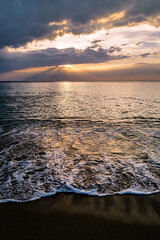 Sunset on the beach with waves.