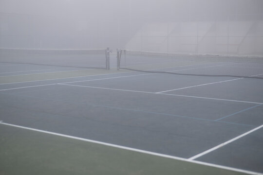 Tennis and raquetball courts  in murky mysterious grey fog