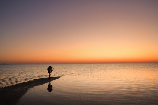 Profile young girl dancing at sunset reflection Caper Hatteras N