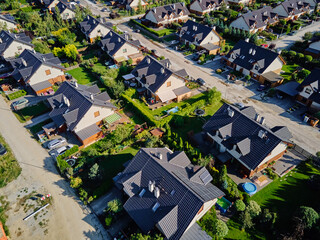 Aerial view of suburb with family houses, gardens and driveways. Residential neighborhood