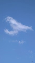Unique Cloud Formation in a Bright Blue Sky Captured During Daylight Hours