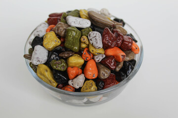 Turkish rocks chocolate, in a transparent bowl, isolated on white background