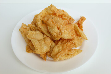 Kerupuk pangsit, or crispy fried skin dumpling, isolated in white background