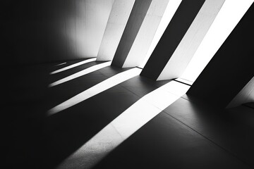 Abstract architectural interior, light and shadow play on a concrete structure.  Vertical beams create a stark contrast between light and dark