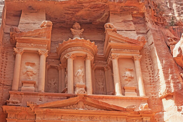Closeup view of Al-Khazneh (The Treasury), most famous temple in Petra, an ancient city of the Nabatean Kingdom  in Jordan.  Photo in red tones.