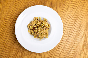 Top view of a tagliatelle in creamy gorgonzola and pistachio sauce
