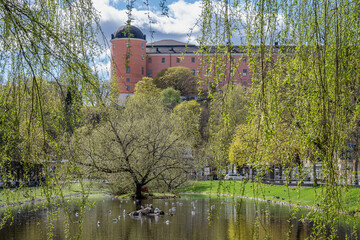 Uppsala Castle viewed from pond Svandammen on a sunny spring day in Sweden in late April 2025. Construction of the famous castle began in 1549 and completed in the early 17th century.