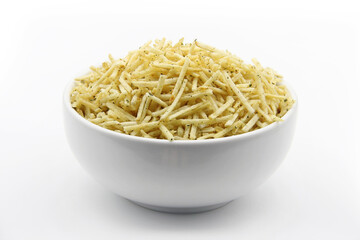 STRAW POTATOES IN A WHITE BOWL WITH ONION AND PARSLEY FLAVOR ON AN ISOLATED WHITE BACKGROUND