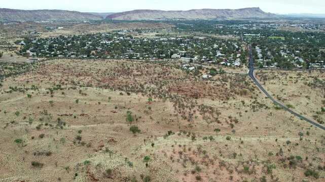 Aerial view looking west along Udoolya Road and Alice Srings, Mparntwe, with the MacDonnell Ranges in the distance. Northern Territory, Australia. August 2022.