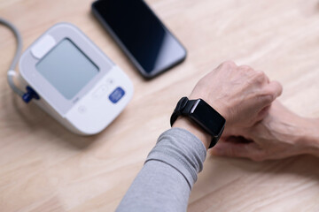 Woman taking blood pressure test on smartwatches, blank for copy-space