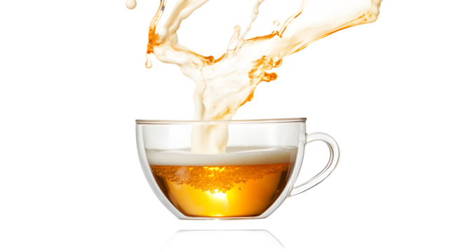 A cup of tea is poured into a glass, creating a splash of liquid