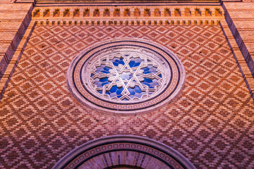 Ornate Synagogue Facade with Intricate Star of David Rose Window and Geometric Brickwork Pattern