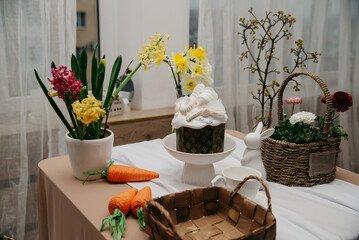 Easter celebration items, wicker basket, carrots, decorative flowers, background for a subject...