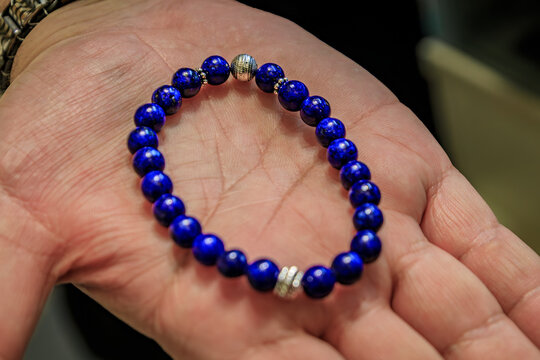 Jeweler shows a custom made lapis lazuli bracelet made at Grand Bazaar, Istanbul, Turkey