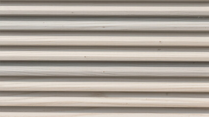 Close up of a textured wooden wall showing a natural pattern with parallel lines