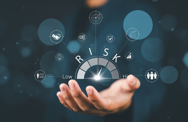 Risk Management and Assessment Concept. A man holding digital risk gauge in their hand, with icons...