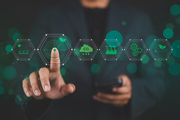 Green Energy and Sustainability Concept. Man with icons represent green energy, sustainability, environmental conservation, modern eco friendly technology. Carbon footprint, target sustainability