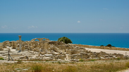 Ancient Stone Ruins Overlooking the Vibrant Blue Ocean with Clear Skies