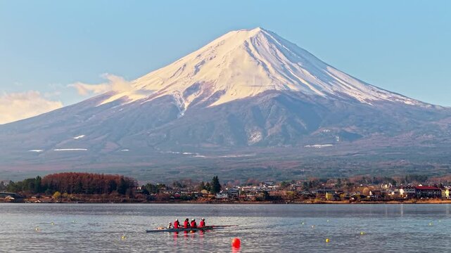 Aerial drone view of a rowing team of four people with a coxswain seated at the front practicing on Lake Kawaguchiko, with Mount Fuji on the background, Fujikawaguchiko, Japan