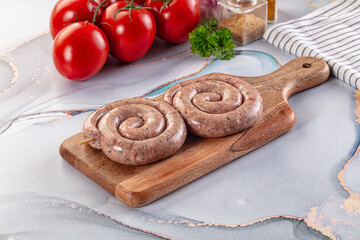 Raw meat pork and beef swirl sausages