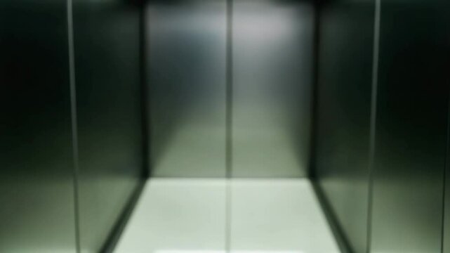 Modern building interior architecture featuring closed metal elevator door with sleek design and narrow opening symbolizing termination and transition