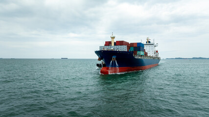 container ship carrying goods for international import export, business and industry regarding...