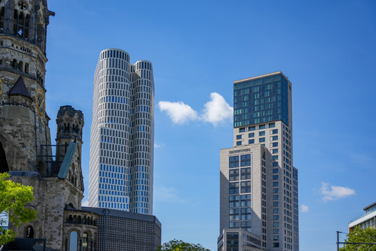 Germany Berlin May 11, 2025. Modern skyscrapers with the Memorial Church. The modern skyline of Berlin with the Kaiser Wilhelm Memorial Church in the foreground, flanked by the Zoofenster Waldorf Asto