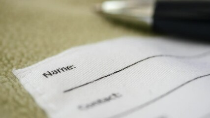 Filling out contact details on a child jacket 