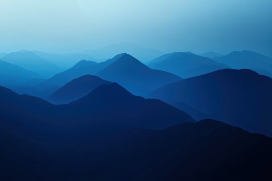 Misty blue mountain range stretching into the distance.  A soft gradient of blue hues creates a serene and tranquil atmosphere