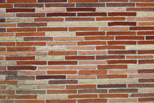 Mur de briques de couleur rouge, rose, orange