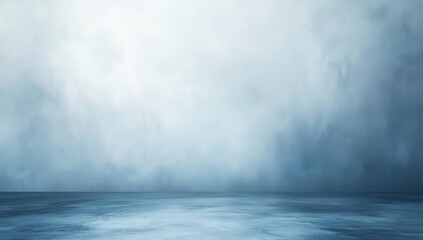 Empty, muted blue studio backdrop with soft, hazy texture