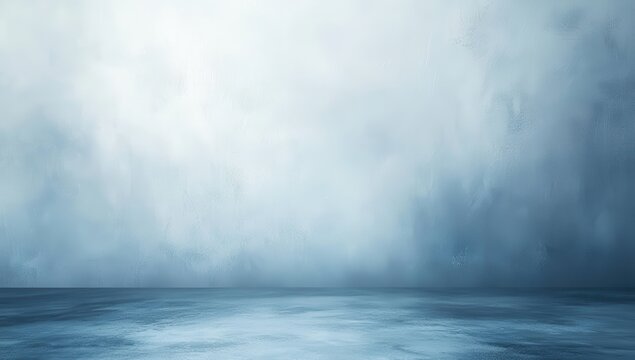 Empty, muted blue studio backdrop with soft, hazy texture