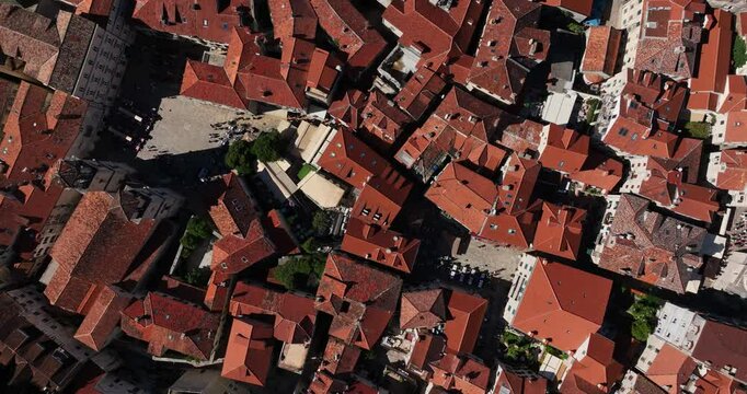 Medieval city Budva traditional stone houses with red roof in old town, Church of Saint John the Baptist, Budva Citadel, Overhead drone shot