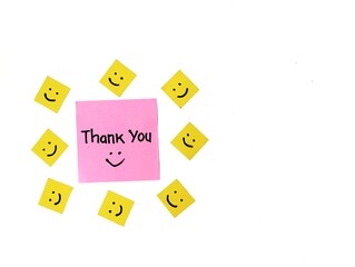 Thank you message on pink note paper isolated on white background with smile emoji 