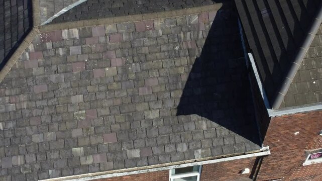Rooftop survey aerial view inspecting damage and repair of real estate for homeowner