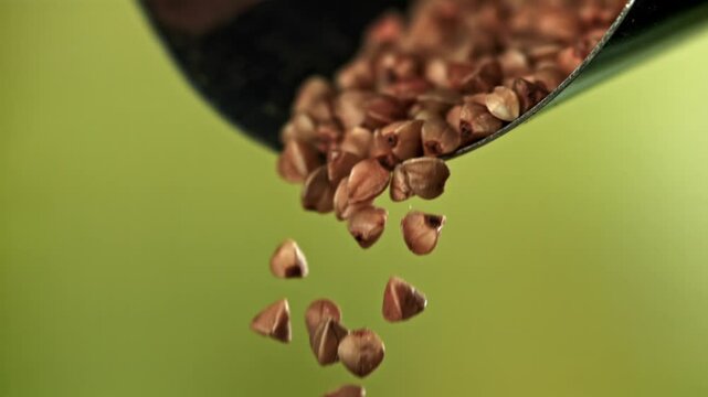 Buckwheat falls from the scoop. Filmed on a high-speed camera at 1000 fps. High quality FullHD footage