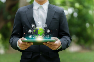 Businessman analyze sustainability investment and holding green globe. Concept of ESG, Green...