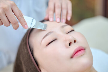 Female Facial Skin Treatment with Beauty Device at Spa