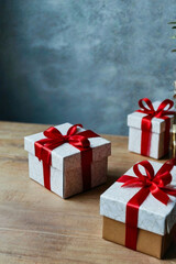 Obraz premium gift box tied with red ribbon rope, minimalist and elegant gift box, on wooden table, close up, studio lighting